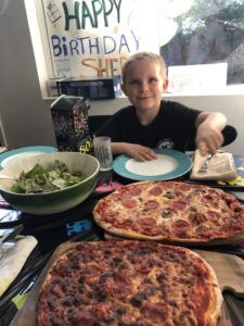 It shows a picture of my son on his 8th birthday with pizza.