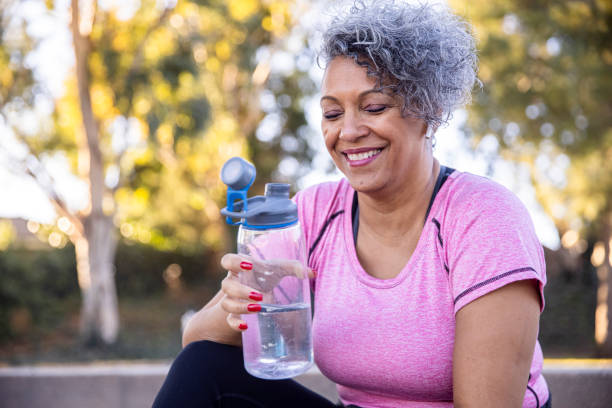 50+ woman, hydrating, workout