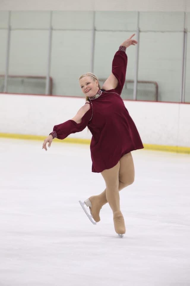 Woman 50+ ice skating at rink